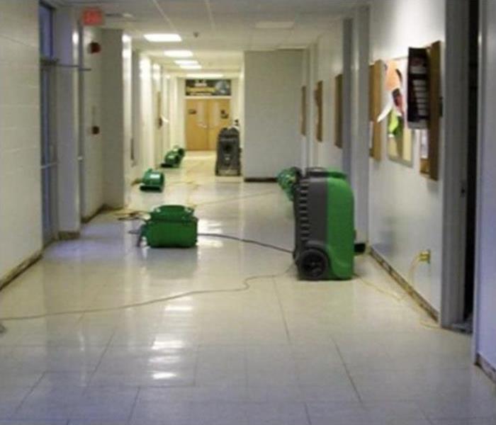 Air movers placed in the hallway of a commercial building in Waynesville, NC