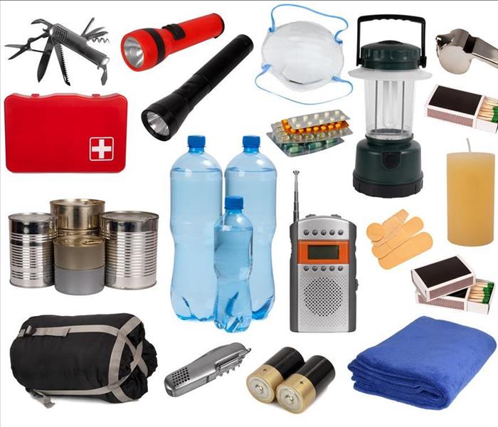 Flash light, sleeping bag, bottled water, first aid, portable radio, matches, medicine, band aids, whistle, blanket. 