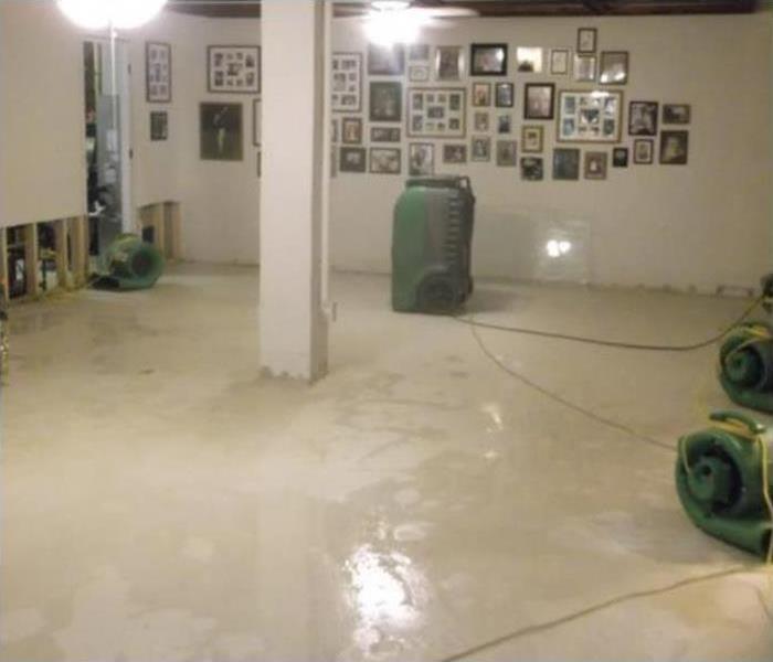 Air movers and dehumidifiers placed in a flooded home